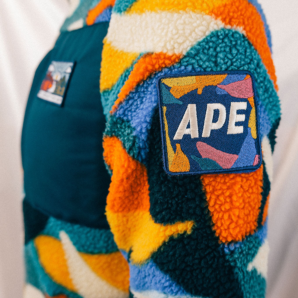 Out There Recycled Sherpa Fleece (Banana Camo Forest/Orange)